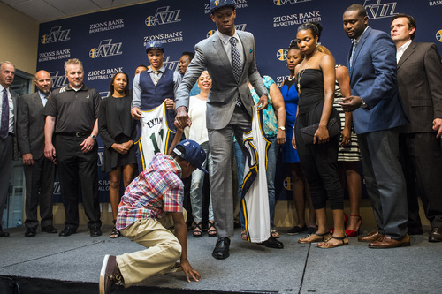 Chris Detrick  |  The Salt Lake Tribune
Utah Jazz's Rodney Hood helps his nephew Ricky Hood III, 5, get onto the stage for a group picture during a press conference at the Zions Bank Basketball Center Friday June 27, 2014.