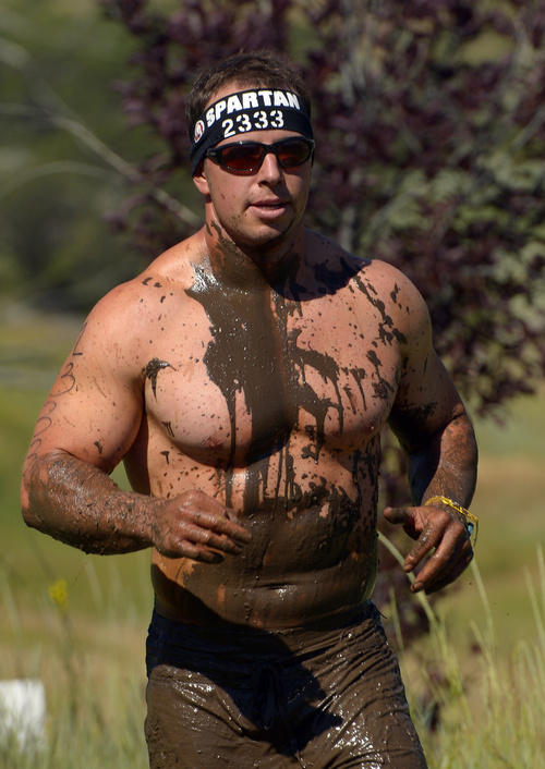 Rick Egan  |  The Salt Lake Tribune

A mud-covered Spencer Perry, runs in the 2014 Salt Lake City Spartan Beast race, at Soldier Hollow, Saturday, June 28, 2014.  Spartan Beast Competitors face 29 obstacle's in the 12 mile run.
