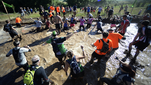 Rick Egan  |  The Salt Lake Tribune

Runners leap into the moat, in the 2014 Salt Lake City Spartan Beast race, at Soldier Hollow, Saturday, June 28, 2014.  Spartan Beast Competitors face 29 obstacle's in the 12 mile run.