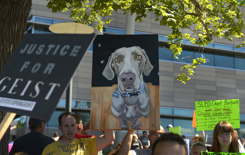 Leah Hogsten  |  The Salt Lake Tribune
Marchers carried a portrait of Geist. Hundreds of supporters of Sean Kendall and his dog, Geist, who was shot and killed in his backyard by a Salt Lake City police officer during a search for a missing child, rally to protest the officer's action, Saturday, June 28, 2014 at the SLC Police headquarters.