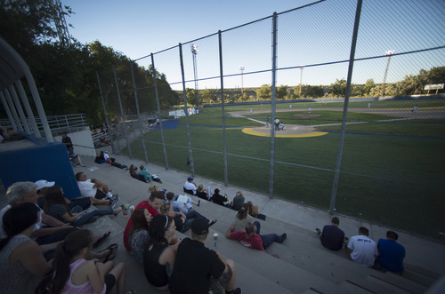 Rick Egan  |  The Salt Lake Tribune

Baseball fans watch a game between Tooele and Cyprus, at Utah Copper Park in Magna, Monday, June 30, 2014