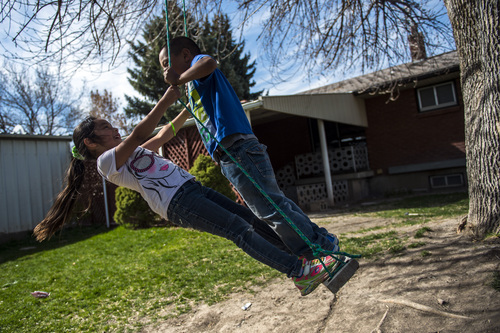 Chris Detrick  |  The Salt Lake Tribune
Luis Granda, 8, and Katy Granda, 6, play on a swing at their home in Garland Wednesday April 16, 2014. Part of the family has been ordered to be deported to El Salvador.