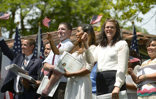 Leah Hogsten  |  The Salt Lake Tribune
L-r Paul Brouwer, Pedro Eduardo Albornoz Zapata, Daniel Webster, Emilia Huebsch, Ranae Charlyn Broadhead and Octavia Schubert cheer after becoming U. S. citizens. Fifteen new U.S. citizens from 13 countries became sworn citizens by U.S. Citizenship and Immigration Services as part of the America's Freedom Festival, Wednesday, July 3, 2014 in Orem's Scera Park.  Orem's ceremony is among 100 naturalization ceremonies immigration is having between June 30 and July 4.