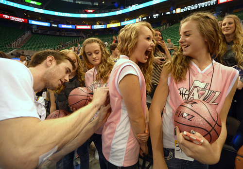 Rick Egan  | The Salt Lake Tribune 

Brooklyn Carter (left) watches as Utah Jazz guard Gordon Hayward (20) signs Aspen Marshall,s shirt (center), Tylee Brown is on the right, before the Jazz vs. Magic game, at EnergySolutions Arena Saturday, March 22, 2014.