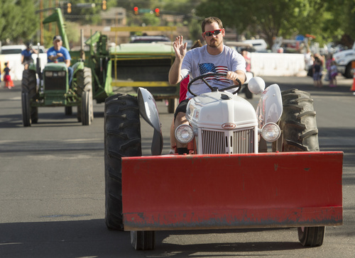 Rick Egan  |  The Salt Lake Tribune

Tractors make their way down the parade route, in the Hurricane Independence day Parade,  Friday, July 4, 2014