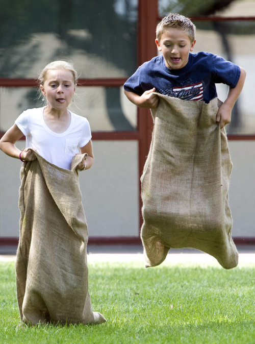 Rick Egan  |  The Salt Lake Tribune

Eight-year-old Shelby Green, and Aspen Borden, 9, compete in the gunny sack races, during the Hurricane Independence day festivities,  Friday, July 4, 2014