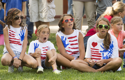 Rick Egan  |  The Salt Lake Tribune

Patriotic kids watch the races during the  Hurricane Independence day activities , Friday, July 4, 2014