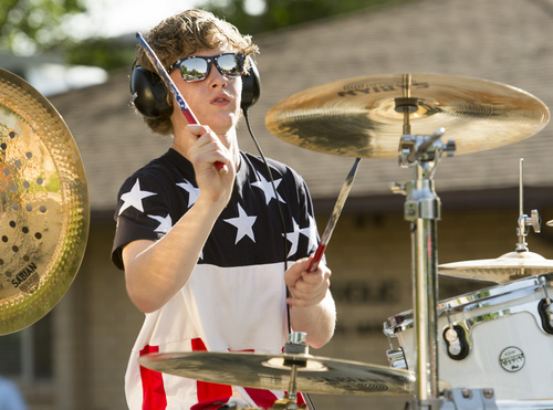 Rick Egan  |  The Salt Lake Tribune

Jordan Coleman, 15, plays the drums in the back of a pick-up truck, in the Hurricane Independence day Parade,  Friday, July 4, 2014