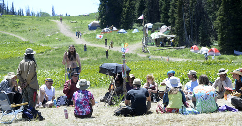 Al Hartmann  |  The Salt Lake Tribune 
Mostly elder members of  the Rainbow Family talk over camp business and issues in the council circle at their camp in the Uinta Mountains 15 miles northeast of Heber.  There is no one leader.  The council talks over problems calmly with the talker holding a feather.  No one is interupted.  Members of the council talk individually until a consensus is achieved.