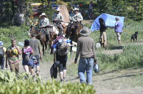 Al Hartmann  |  The Salt Lake Tribune 
Forest Service law enforcement officers patrol the trails and camping areas at the  Rainbow Family Gathering in the Uinta Mountains 15 miles northeast of Heber.