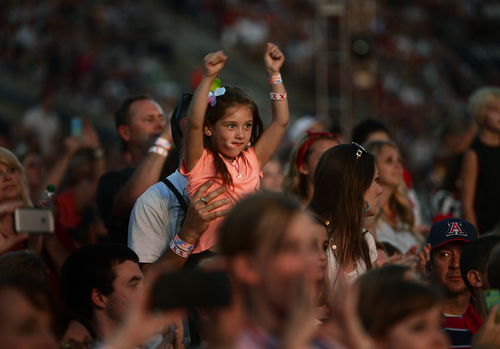 Scott Sommerdorf   |  The Salt Lake Tribune
A father lifts up his young daughter as Carrie Underwood performs at the "Stadium of Fire" in Provo, Friday, July 4, 2014.