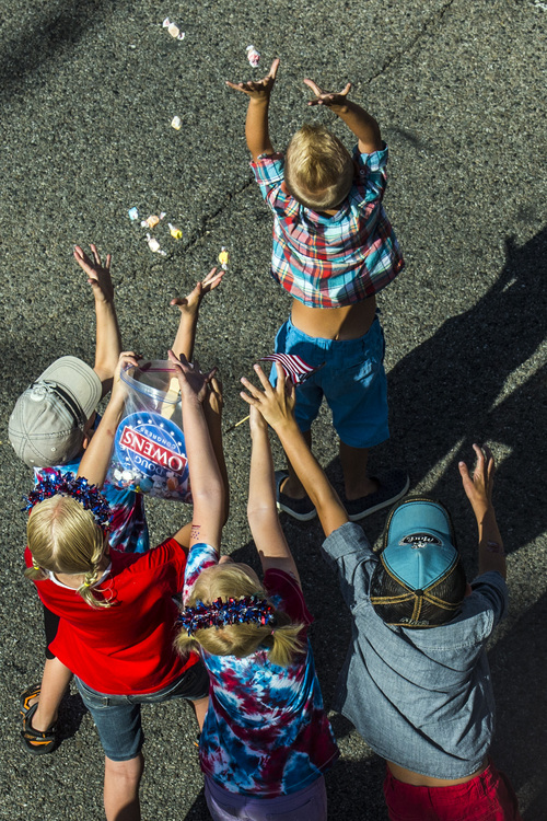Chris Detrick  |  The Salt Lake Tribune
Children try to catch thrown candy during the Murray 2014 Fun Days Parade along State Street Friday July 4, 2014.