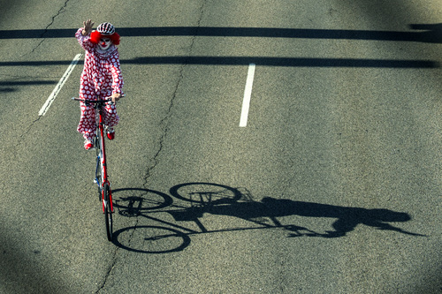 Chris Detrick  |  The Salt Lake Tribune
A clown on a double-decker bike rides in the Murray 2014 Fun Days Parade along State Street Friday July 4, 2014.