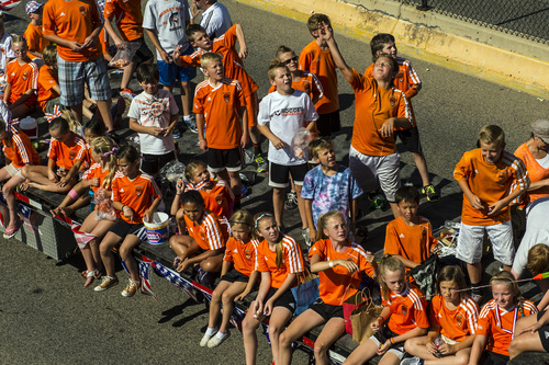 Chris Detrick  |  The Salt Lake Tribune
Children ride on the back of a truck in the Murray 2014 Fun Days Parade along State Street Friday July 4, 2014.