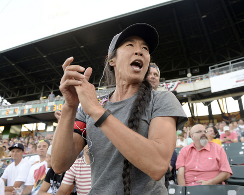 Al Hartmann  |  The Salt Lake Tribune 
Bees fan Anita Tsuchlya cheers for the team behind the dugout at the Bees-Tacoma game Monday July 7.  She's been a serious fan since 1998.  She's seen four general managers come and go.