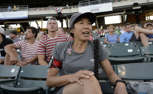 Al Hartmann  |  The Salt Lake Tribune 
Bees fan Anita Tsuchlya cheers for the team behind the dugout at the Bees-Tacoma game Monday July 7.  She's been a serious fan since 1998.  She's seen four general managers come and go.