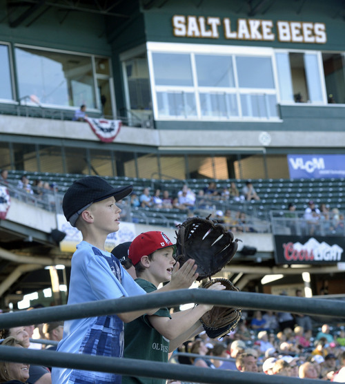 Al Hartmann  |  The Salt Lake Tribune 
Young fans hold out mitts for a foul ball in the stands at Bee's baseball game vs. Tacoma Monday July 7.