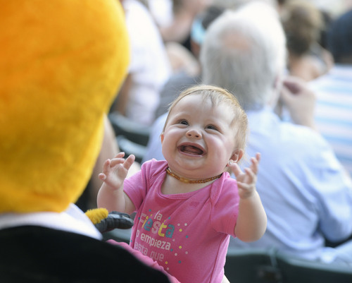 Al Hartmann  |  The Salt Lake Tribune 
Young Bees fan is enchanted by "Bumble" the official Bee's mascot at the Bees-Tacoma game Monday July 7.