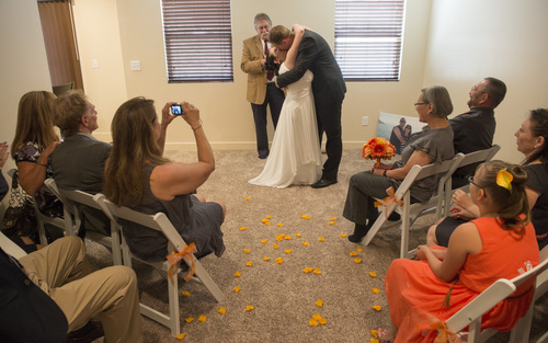 Rick Egan  |  The Salt Lake Tribune
Tribune columnist, Robert Kirby performs a wedding for Jerri Lynn Moore  and Zachary Peter Hans at their home in Herriman on Monday, July 7, 2014.