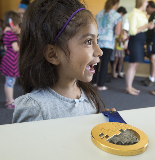 Steve Griffin  |  The Salt Lake Tribune


Four-year-old Arianna Avila smiles as she gets an autograph from Olympic champion Ted Ligety during his visit to the Taylorsville YMCA Summer Day Camp in Taylorsville, Utah Monday, July 7, 2014.  This past winter the YMCA of Northern Utah partnered with the U.S. Ski and Snowboard Association, National Winter Sports Education, Ted Ligety and Park City Mountain Resort to give youth in the YMCA programs a chance to learn how to ski.