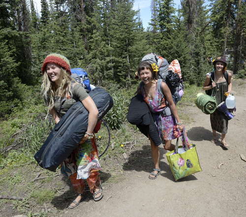Al Hartmann  |  The Salt Lake Tribune 
Members of the Rainbow family carry their backpacks and camping gear up "Heart attack Mesa" a steep foot trail into the Rainbow Family Gathering in the Uinta Mountains 15 miles northeast of Heber.  The walk in from the parking lot to the camping area is about 2 miles.
