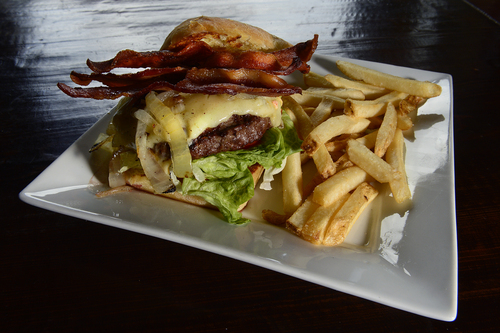 Scott Sommerdorf   |  The Salt Lake Tribune
The half-pound Angus Burger with grilled onions, white cheddar, tomato aioli, bacon, and fries at the Honeycomb Grill (formerly Kimi's) at Solitude Mountain Resort.