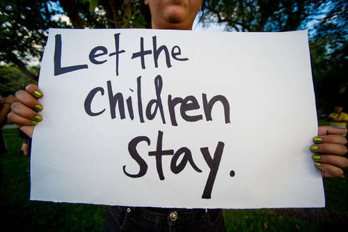 Trent Nelson  |  The Salt Lake Tribune
Iliana Correa holds a sign at a vigil in Liberty Park in Salt Lake City, Wednesday July 9, 2014. The vigil was against any deportation of unaccompanied migrant children being held in large numbers at the border.