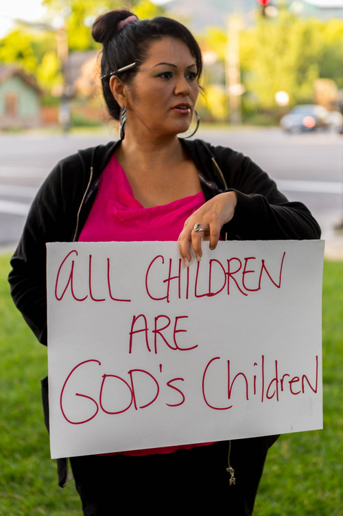Trent Nelson  |  The Salt Lake Tribune
A. Cervantes holds a sign at a vigil in Liberty Park in Salt Lake City, Wednesday July 9, 2014. The vigil was against any deportation of unaccompanied migrant children being held in large numbers at the border.