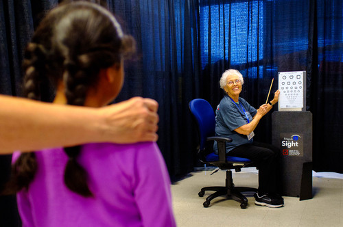 Trent Nelson  |  The Salt Lake Tribune
Volunteer Jane O'Bryant administers a vision screening at the 22nd annual Community Assistance Resource Event in Salt Lake City, Friday July 11, 2014. The event (CARE) provides an array of free medical services to the public including physical exams, women's exams, breast exams, dental exams, STD testing, diabetes and cholesterol screenings, mental health sessions and immunizations.