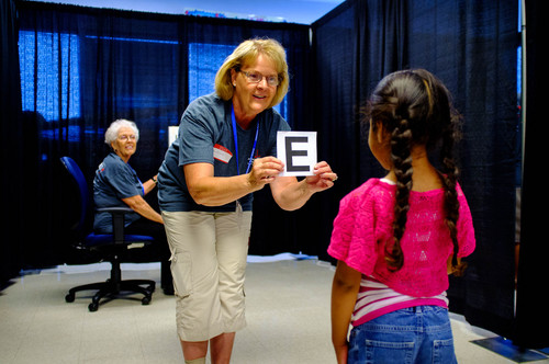 Trent Nelson  |  The Salt Lake Tribune
Volunteer Christine Richards administers a vision screening at the 22nd annual Community Assistance Resource Event in Salt Lake City, Friday July 11, 2014. The event (CARE) provides an array of free medical services to the public including physical exams, women's exams, breast exams, dental exams, STD testing, diabetes and cholesterol screenings, mental health sessions and immunizations. At left is Jane O'Bryant.