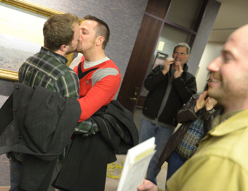Keith Johnson | The Salt Lake Tribune

Jason Dautel, left and Micah Unice kiss after being married by officiant Derek Snarr outside the Salt Lake County clerks office, Friday, December 20, 2013. A federal judge in Utah Friday struck down the state's ban on same-sex marriage, saying the law violates the U.S. Constitution's guarantees of equal protection and due process.