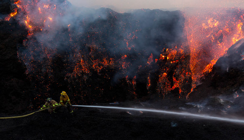 Trent Nelson  |  The Salt Lake Tribune
Firefighters work to control a fire at a mulch plant near 3300 South and I-15, in Salt Lake City, Thursday July 10, 2014.