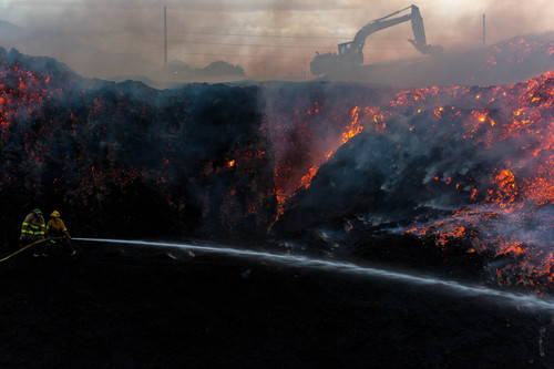Trent Nelson  |  The Salt Lake Tribune
Firefighters work to control a fire at a mulch plant near 3300 South and I-15, in Salt Lake City, Thursday July 10, 2014.