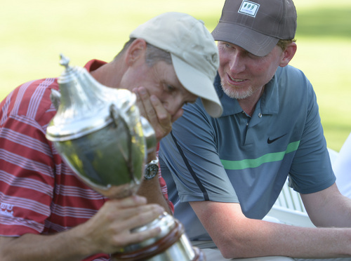 Leah Hogsten  |  The Salt Lake Tribune
Jon Wright and his caddy Garr Smith (right) celebrate his win. Wright became the 116th Utah State Amateur golf tournament winner for the second time Saturday, July 11, 2014 at Ogden Golf and Country Club.