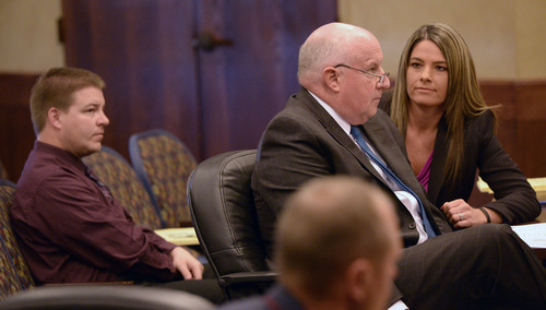 Al Hartmann  |  The Salt Lake Tribune 
Shaun Cowley, left, sits in a pre-hearing conference before the West Valley City Civil Service Commission Tuesday February 18, 2014. His defense lawyers Keith Stoney and Lindsay Jarvis represent him. Cowley is fighting to get back on the West Valley City Police force.
