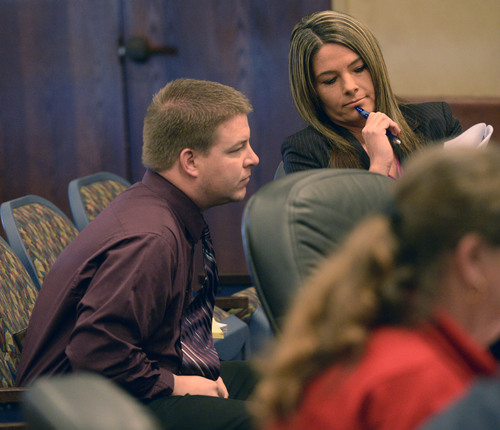 Al Hartmann  |  The Salt Lake Tribune 
Shaun Cowley, left, talks to his defense lawyer Lindsay Jarivis in a pre-hearing conference before the West Valley City Civil Service Commission Tuesday February 18, 2014. Cowley is fighting to get back on the West Valley City Police force.