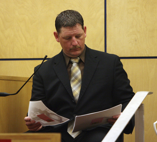 Steve Griffin  |  Tribune file photo

West Valley City Police detective, Ellis Maxwell, looks at evidence, from the witness stand, during the trial for Steve Powell in Judge Ronald E. Culpepper's courtroom in the Pierce County Superior Court  in Tacoma, Washington, on May 14, 2012.