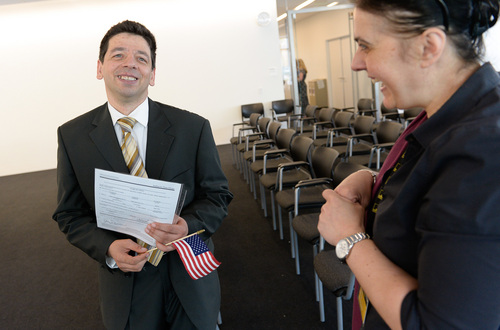 Francisco Kjolseth  |  The Salt Lake Tribune
Hussein-Jake Kadhim is all smiles as he is joined by Tanya Micic,  immigration coordinator for the International Rescue Committee in Salt Lake City and the first person he met in Utah. Kadhim, who worked as a translator for the U.S. Army in his native Iraq, was sworn in as an American citizen on Friday at the new federal courthouse in Salt Lake City.