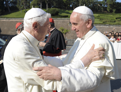 FILE - In this july 5, 2013 file photo provided by the Vatican newspaper L'Osservatore Romano, Pope emeritus Benedict XVI, left, is welcomed by Pope Francis during a ceremony for the unveiling of San Michele Arcangelo statue at the Vatican. The Vatican has cast doubt on the possibility that Argentine Pope Francis and his predecessor, German Pope Emeritus Benedict XVI, would get together to watch their home teams in the World Cup final on Sunday, July 13, 2014. (AP Photo/L'Osservatore Romano, ho)
