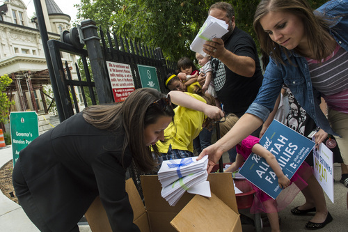 Chris Detrick  |  The Salt Lake Tribune
Megan Berrett, of Salt Lake City, helps to deliver signed petitions outside of the Governor's Mansion in Salt Lake City Wednesday July 9, 2014. Utah Unites for Marriage delivered more than 3,800 signatures collected on a petition urging Governor Gary Herbert and Attorney General Sean Reyes to end their "relentless court fight to stop same-sex marriage and deny legally married couples recognition and access to second-parent adoptions."