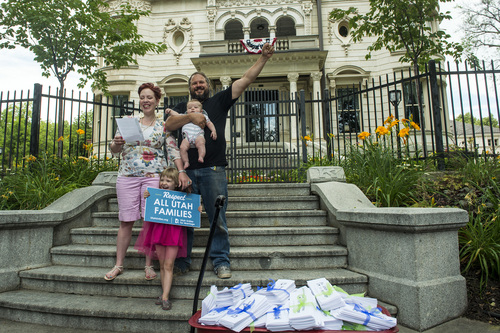 Chris Detrick  |  The Salt Lake Tribune
Joel Otterstrom, Crystal Young-Otterstrom and their kids Edwin, four mouths, and Betty, 4, speak outside of the Governor's Mansion in Salt Lake City Wednesday July 9, 2014. Utah Unites for Marriage delivered more than 3,800 signatures collected on a petition urging Governor Gary Herbert and Attorney General Sean Reyes to end their "relentless court fight to stop same-sex marriage and deny legally married couples recognition and access to second-parent adoptions."