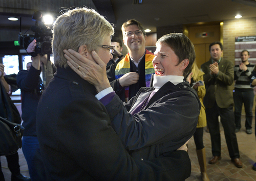 Scott Sommerdorf   |  The Salt Lake Tribune
Laurie Wood, left, and Kody Partridge, right react after being told  that they are officially married by the Rev. Curtis L. Price in the lobby of the Salt Lake County offices, Friday December 20, 2013.