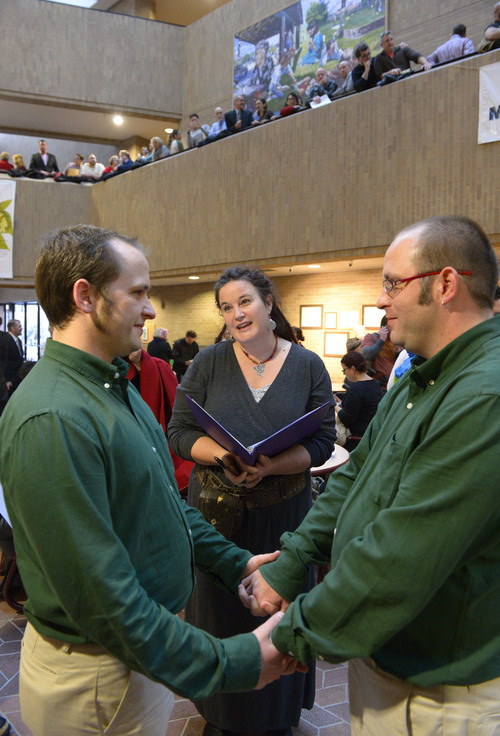 Francisco Kjolseth  |  The Salt Lake Tribune
Nathan London, left, marries his partner of 9-years Alan Britton as Allison Ottley performs the ceremony in the lobby of the Salt Lake County Offices on Monday, Dec. 23, 2013. Hundreds of same-sex couples descended on county clerk offices around the state of Utah to request marriage licenses. A federal judge in struck down the state's ban on same-sex marriage last Friday, saying the law violates the U.S. Constitution's guarantees of equal protection and due process.