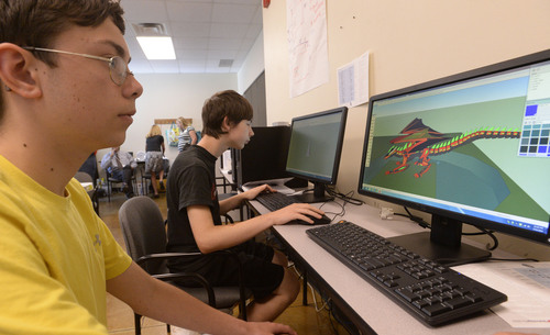 Al Hartmann  |  The Salt Lake Tribune 
Christopher Charles, left, and Steven Sargetakis work on computers with SketchUp Make,  a 3D modeling program.  The University of Utah and Columbus Community Center are testing a pilot program that hopes to eventually connect people with autism with jobs. The pilot project is training 10 high school students in the new technology while also helping them build confidence and social skills.