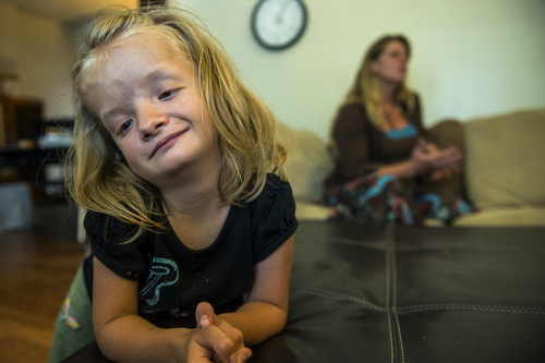 Chris Detrick  |  The Salt Lake Tribune
Alexis Watson, 12, and her mom Angie at their home in Salt Lake City Thursday July 10, 2014. Alexis has a chromosome abnormality called 4p-, 11p trisomy. Watson feels Alexis has the intellectual ability and the desire to attend a typical, first-grade classroom. But she says education officials have told her Alexis would be placed with typical kids of her same age, citing studies showing students with disabilities do better when grouped with peers. Watson feels this type of placement would be inappropriate for Alexis, who is the physical size of a first-grader. She is asking school districts statewide to consider allowing Alexis to attend a first-grade classroom this fall.