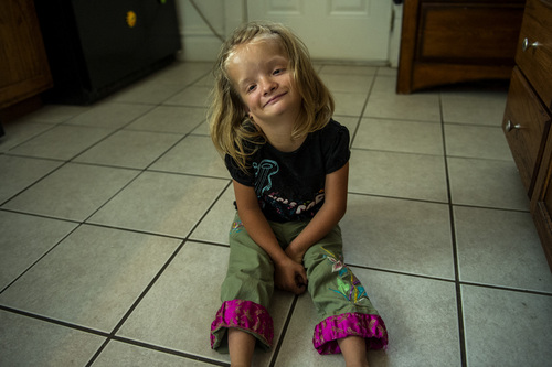Chris Detrick  |  The Salt Lake Tribune
Alexis Watson, 12, plays in her home in Salt Lake City Thursday July 10, 2014.  Alexis has a chromosome abnormality called 4p-, 11p trisomy. Watson feels Alexis has the intellectual ability and the desire to attend a typical, first-grade classroom. But she says education officials have told her Alexis would be placed with typical kids of her same age, citing studies showing students with disabilities do better when grouped with peers. Watson feels this type of placement would be inappropriate for Alexis, who is the physical size of a first-grader. She is asking school districts statewide to consider allowing Alexis to attend a first-grade classroom this fall.