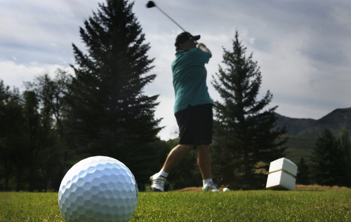 Scott Sommerdorf  |  Tribune file photo             
Larry Lucero tees off while playing golf at Mountain Dell Golf Course, Monday, August 13, 2012.