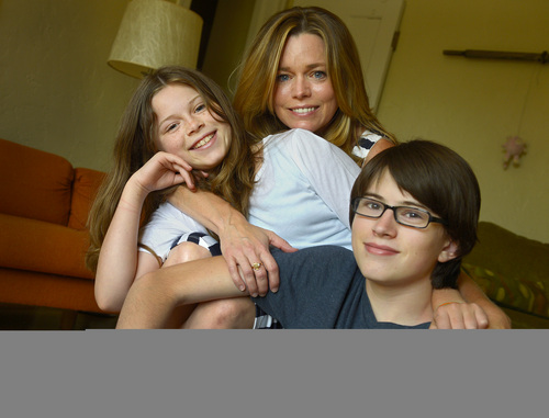 Leah Hogsten  |  The Salt Lake Tribune
 Melanie Soules and her children, Lucy Falkner, 10, and Marshall Falkner, 14, shown at home July 16, 2014 fall in the "coverage gap" of the Affordable Care Act, as do more than 77,000 other Utahns. When Soules, a single mother who suffers from trigeminal neuralgia, a neurological disorder that causes debilitating pain, applied for coverage under the Affordable Care Act last January, she was told she made too little to qualify for a government subsidy but too much to qualify for Medicaid. Soules' children, Marshall Falkner, 14, and Lucy Falkner, 10, also lost their Medicaid coverage.