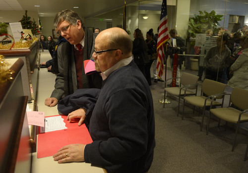 Steve Griffin  |  The Salt Lake Tribune


Gage Church, left, and Tim Sharp fill out paper work as they get their marriage license at the Weber County Clerk's Office in Ogden, Utah Monday, December 23, 2013.