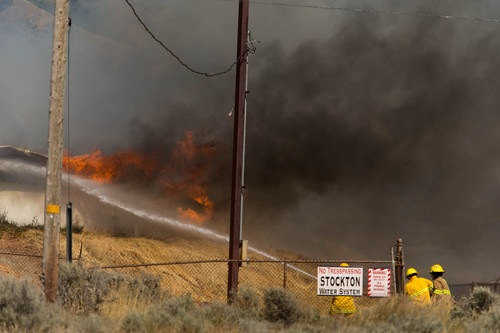 Trent Nelson  |  The Salt Lake Tribune
Firefighters work to extinguish a fire in Stockton, Wednesday July 16, 2014.